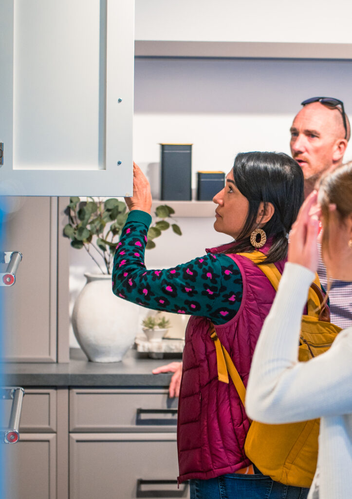 People at the showroom are exploring the kitchen cabinets