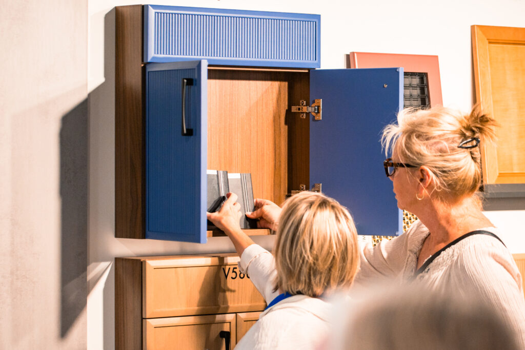 People are in the kitchen showroom
